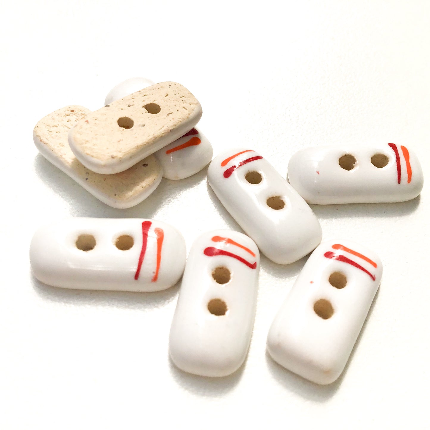 Rectangular White Ceramic Buttons with Orange + Red Lines - White Clay Buttons - 3/8" x 3/4" - 8 Pack